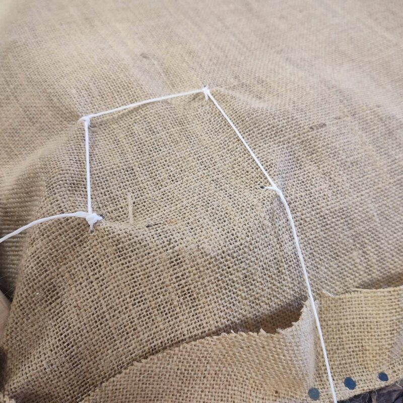 Sewing springs on the hessian